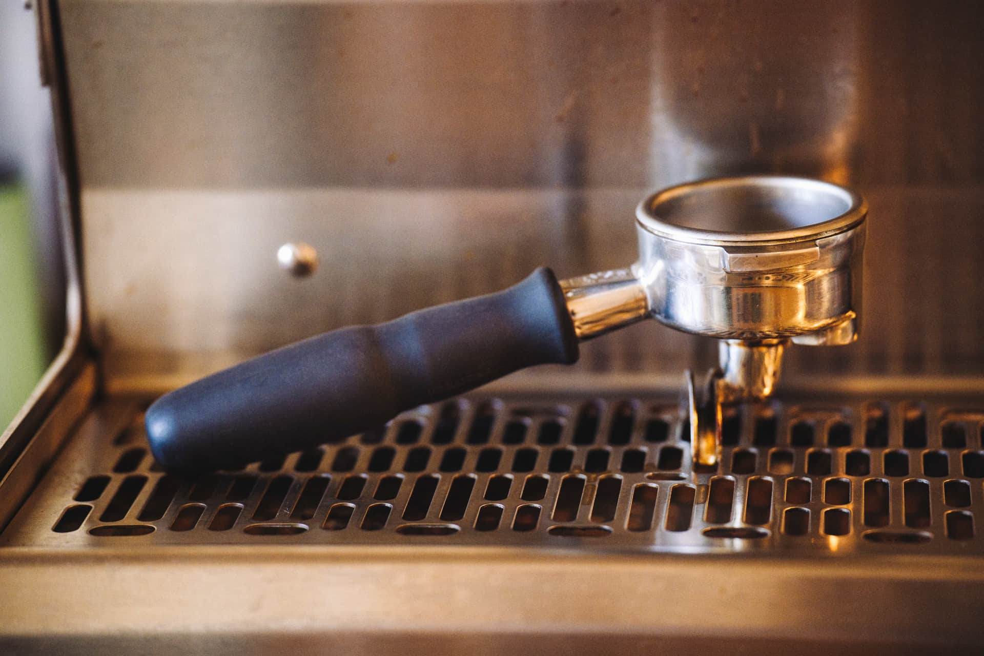 Close view of an espresso machine group head and portafilter