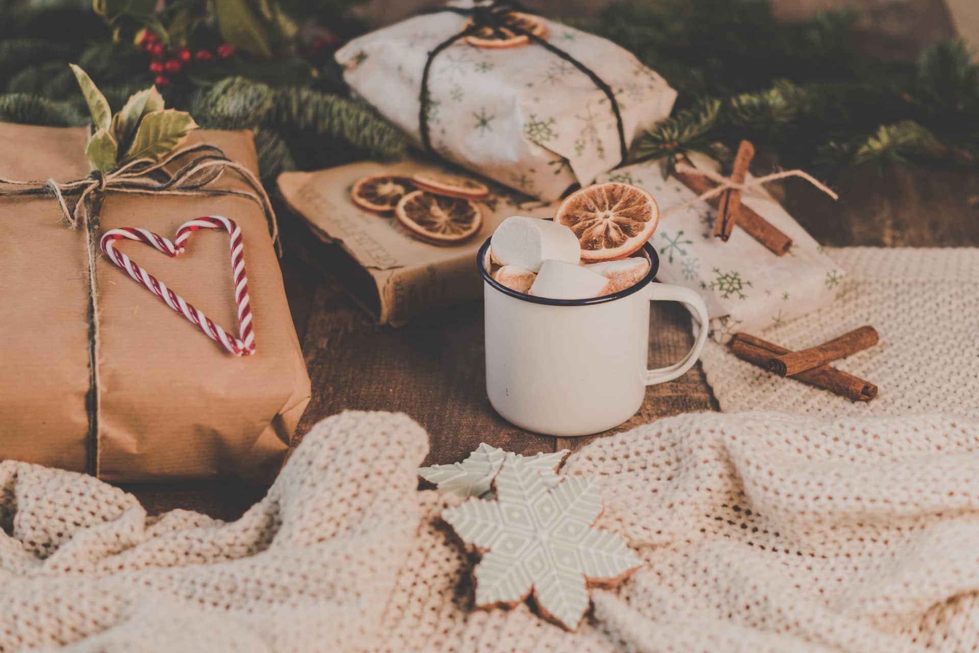 Small wrapped gifts beside a coffee cup