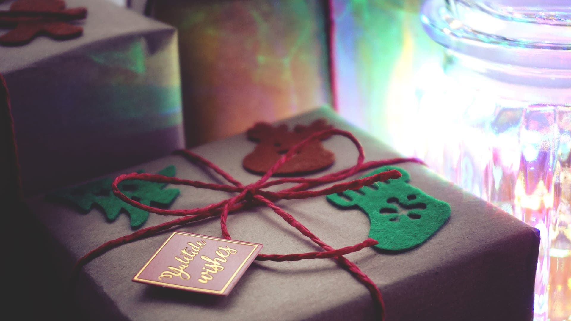 A wrapped gift beside a cup of coffee