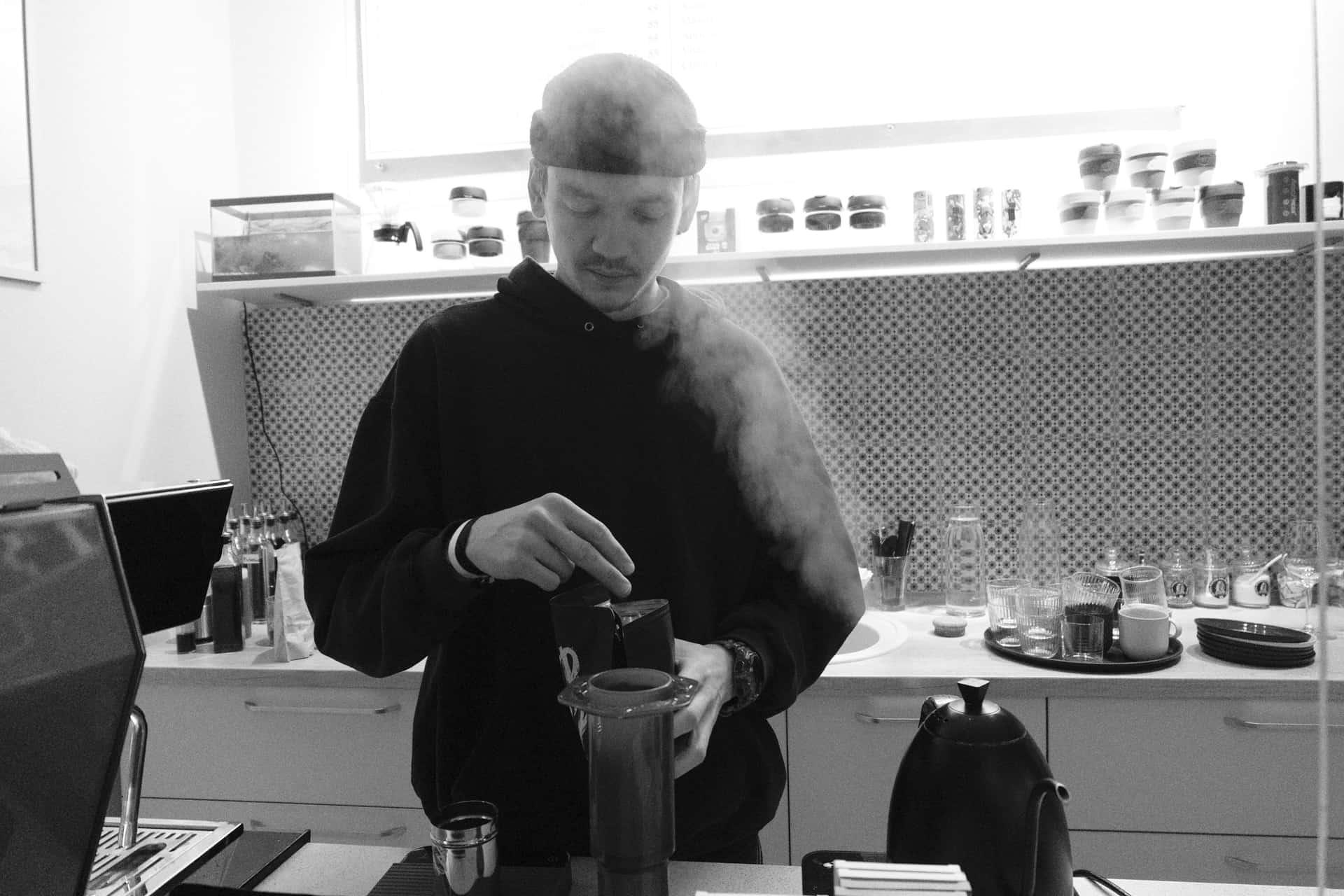 A manual coffee brewer and cup on a kitchen counter