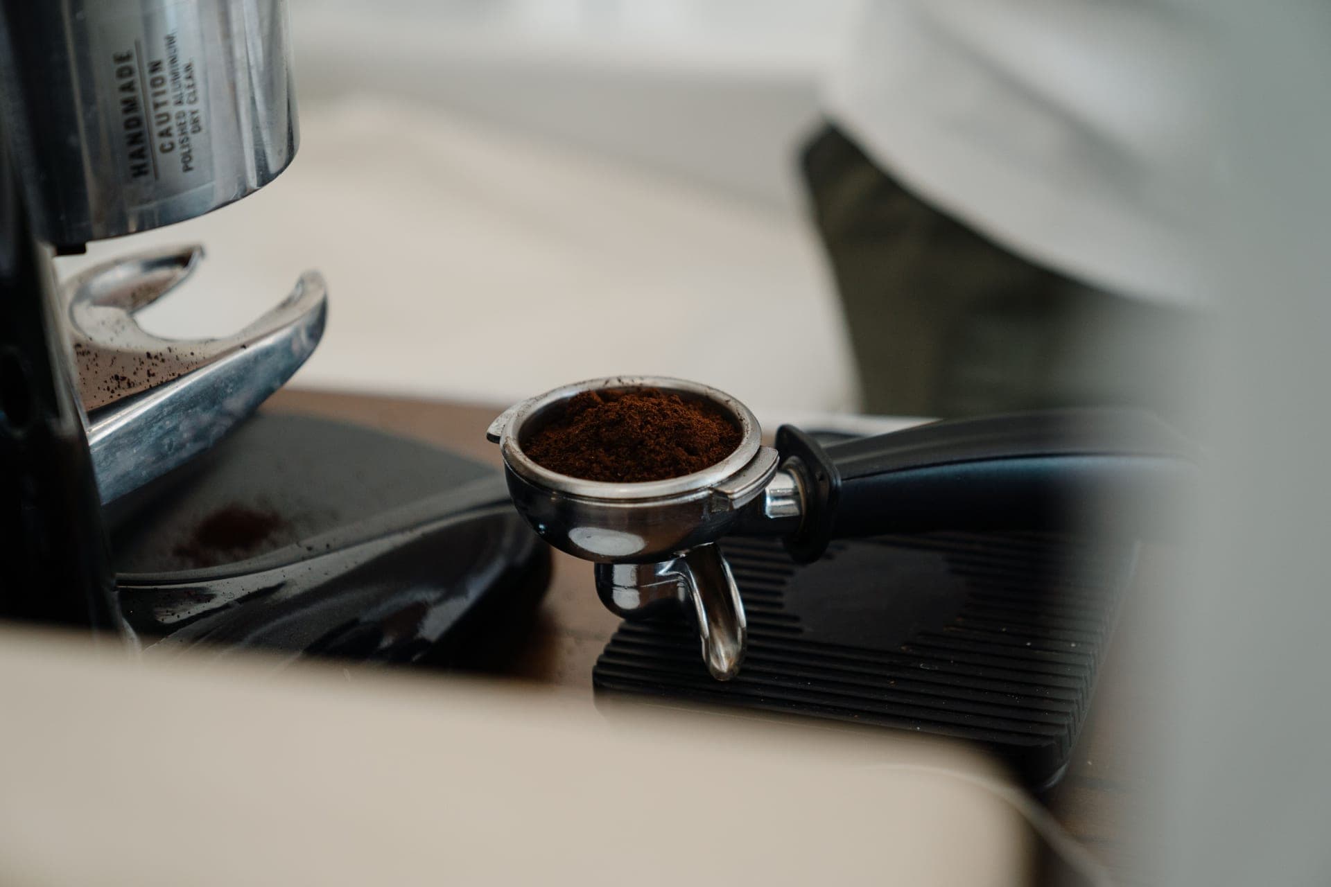A 58 mm portafilter beside a tamper