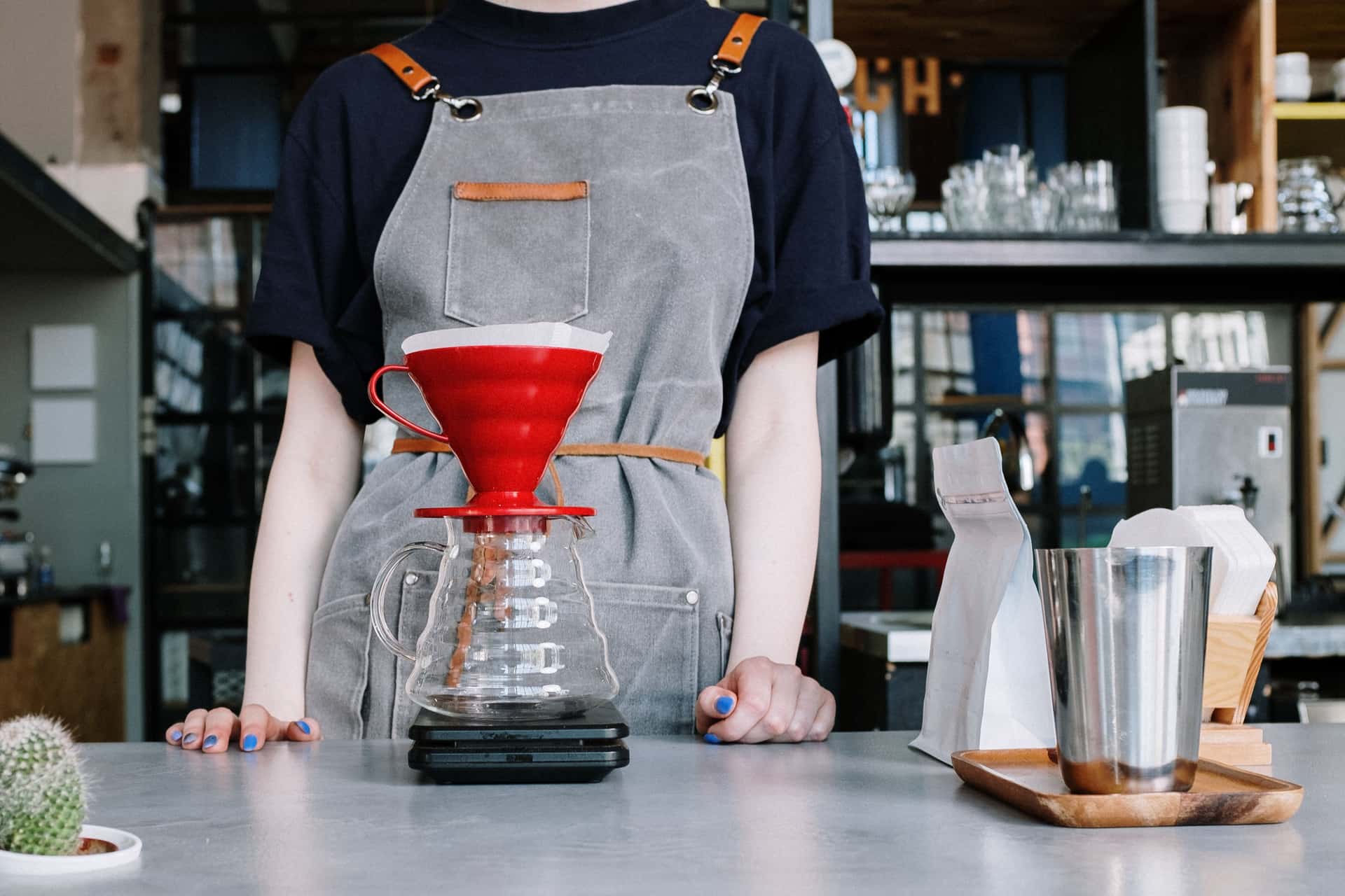 Hot water being poured into a cone dripper over a glass server
