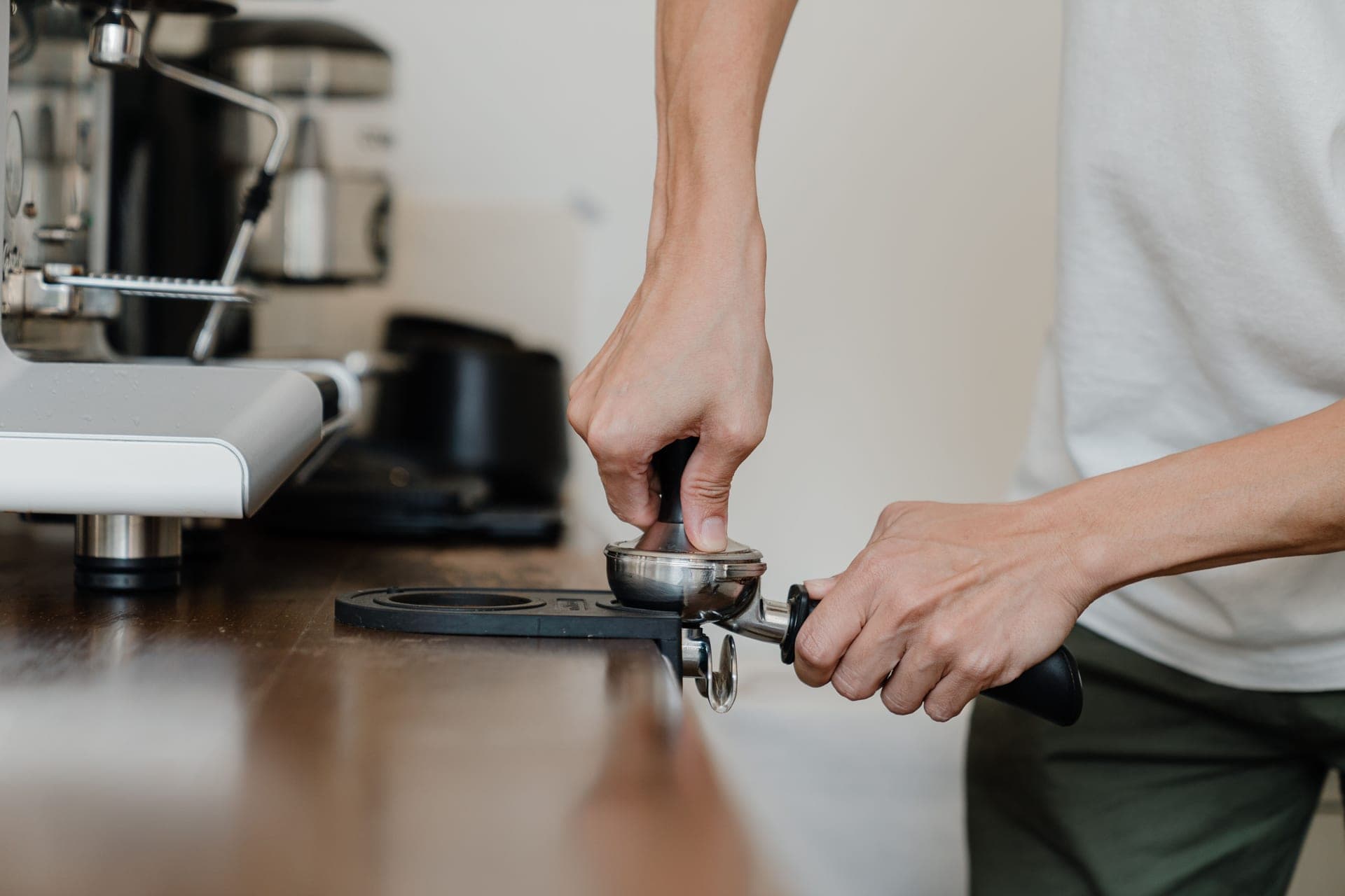 Espresso tools arranged on a wooden counter